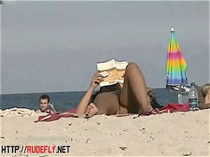 torrid honies filmed lying on a nudist beach
